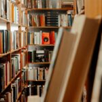 Library aisle with books on wooden shelves
