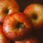 Fresh red apples on a rustic wooden table