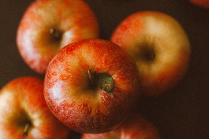Fresh red apples on a rustic wooden table