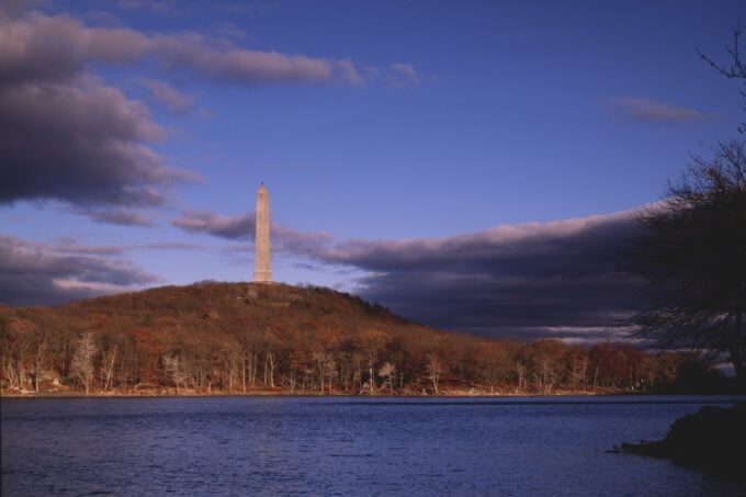 High Point Monument rising above Lake Marcia in autumn, High Point State Park, Sussex County NJ