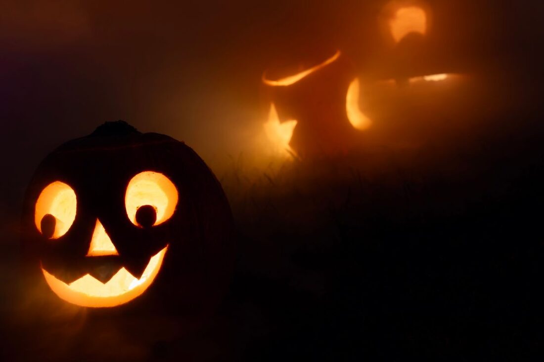 Glowing jack-o'-lanterns in the fog