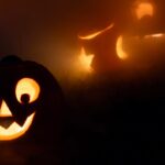 Glowing jack-o'-lanterns in the fog