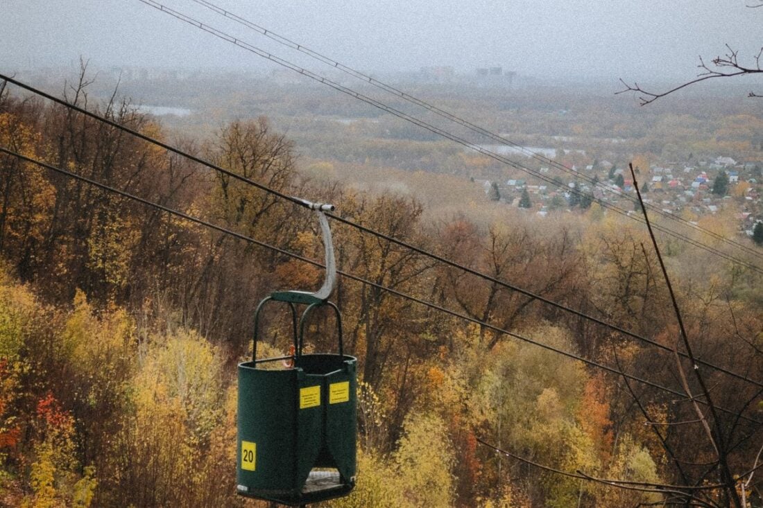 Ski lift over a vibrant autumn forest