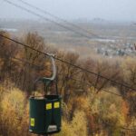 Ski lift over a vibrant autumn forest