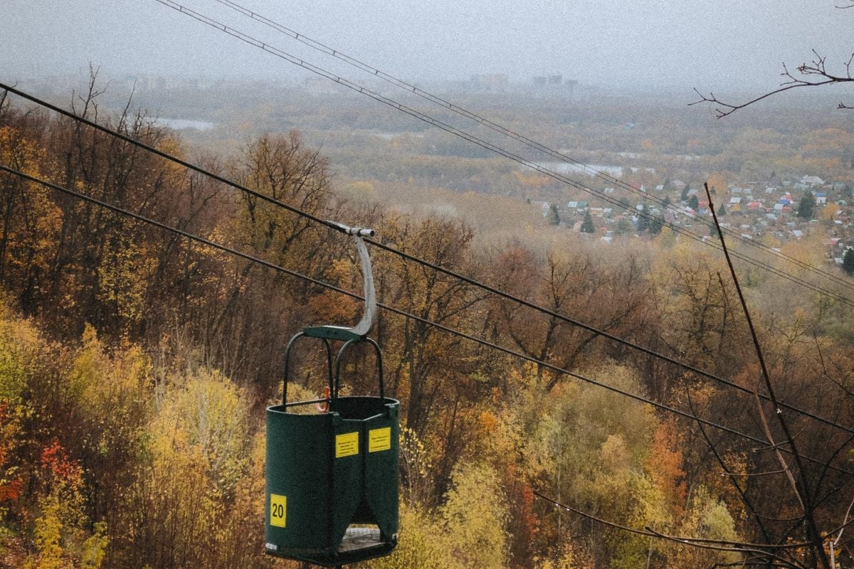 Ski lift over a vibrant autumn forest