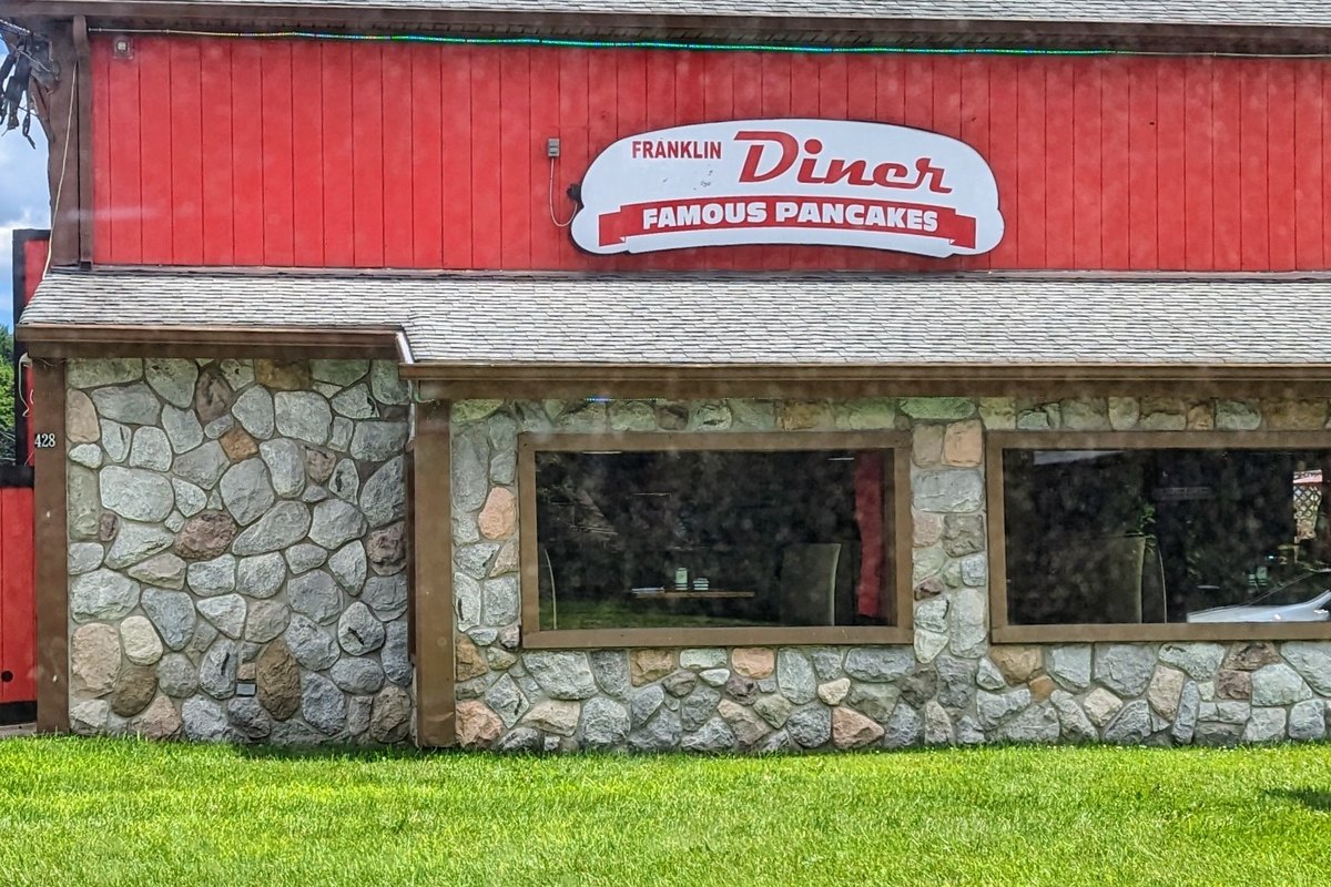 Stone and red barn-style exterior of Angelo's Franklin Diner on Route 23 in Franklin, NJ