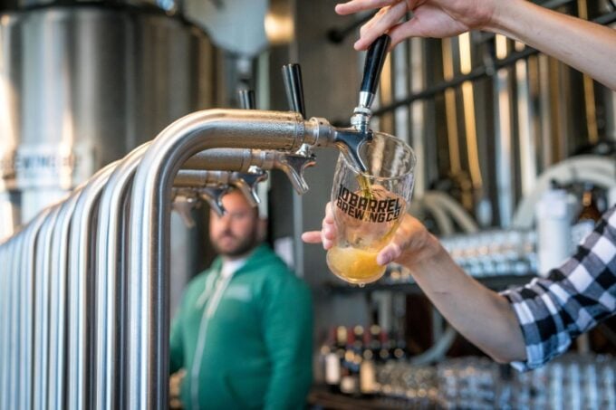 Beer being poured from a tap at a brewery taproom