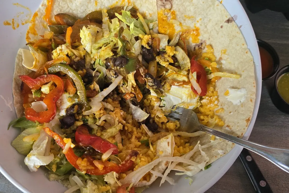 Loaded burrito bowl with peppers and cheese at Coyote Cocina Mexicana on Route 23 in Franklin, NJ