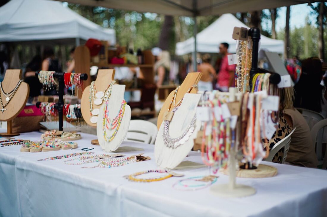 Handmade jewelry on display at a craft fair vendor table
