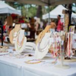 Handmade jewelry on display at a craft fair vendor table