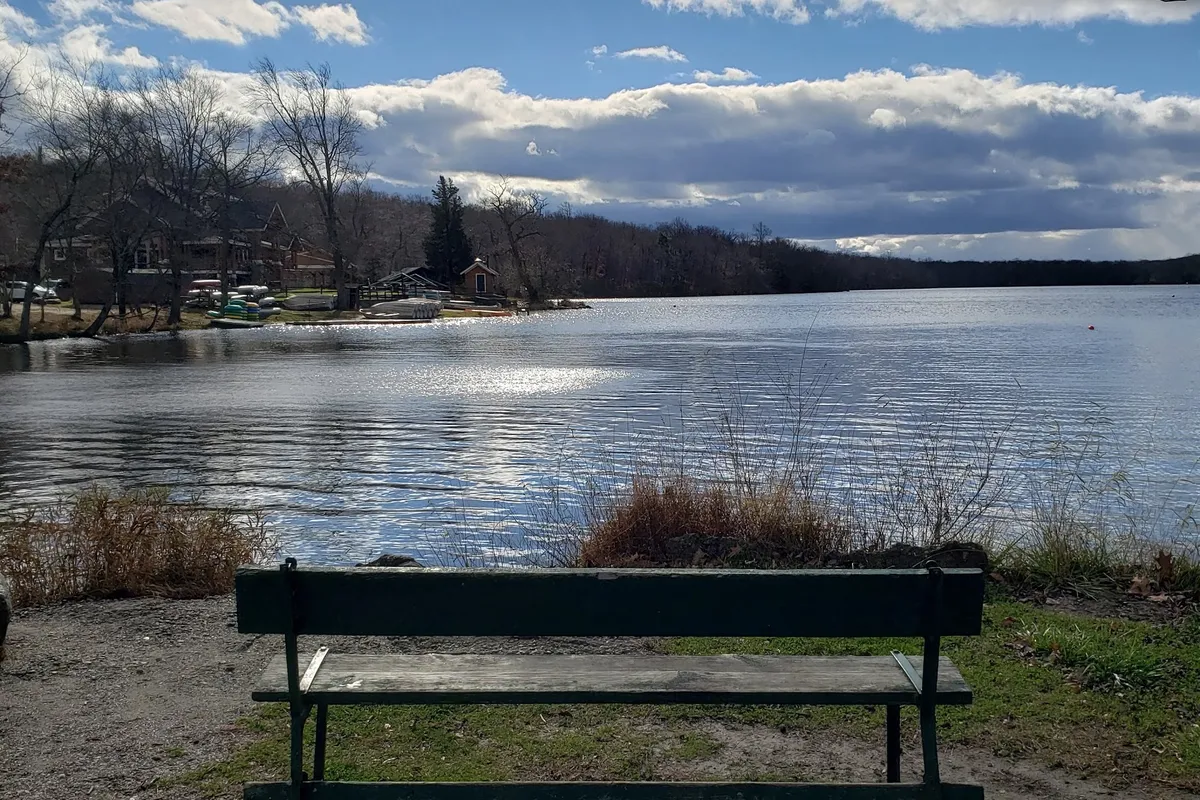 Bench on the shore of Fairview Lake at Fairview Lake YMCA Camps in Stillwater, NJ