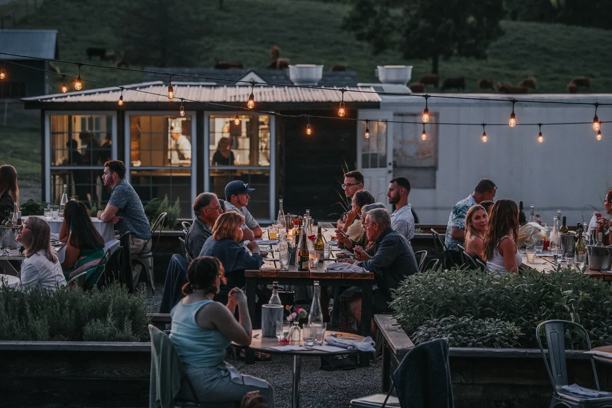 Guests dining outdoors at a farm dinner at The Farm at Glenwood Mountain in Vernon Township NJ
