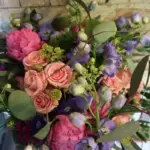Bouquet of peach roses, pink peonies and purple flowers by Farmside Florist in Sussex NJ