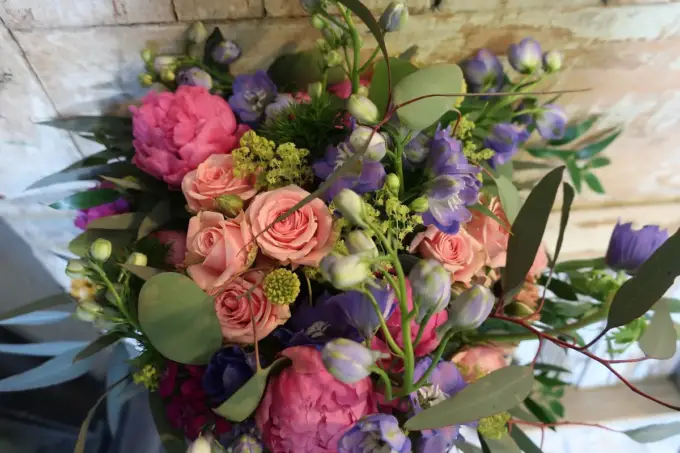 Bouquet of peach roses, pink peonies and purple flowers by Farmside Florist in Sussex NJ