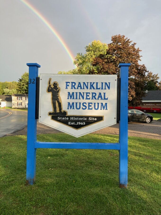 Franklin Mineral Museum entrance sign at 32 Evans Street with rainbow overhead