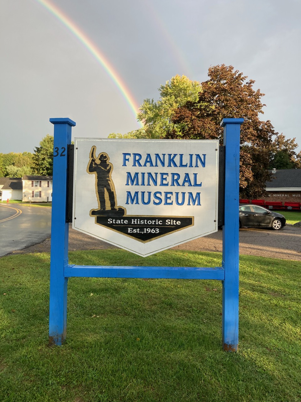 Franklin Mineral Museum entrance sign at 32 Evans Street with rainbow overhead