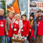 Volunteers in red aprons at the German Christmas Market of NJ at the Sussex County Fairgrounds in Augusta
