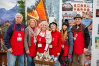 Volunteers in red aprons at the German Christmas Market of NJ at the Sussex County Fairgrounds in Augusta