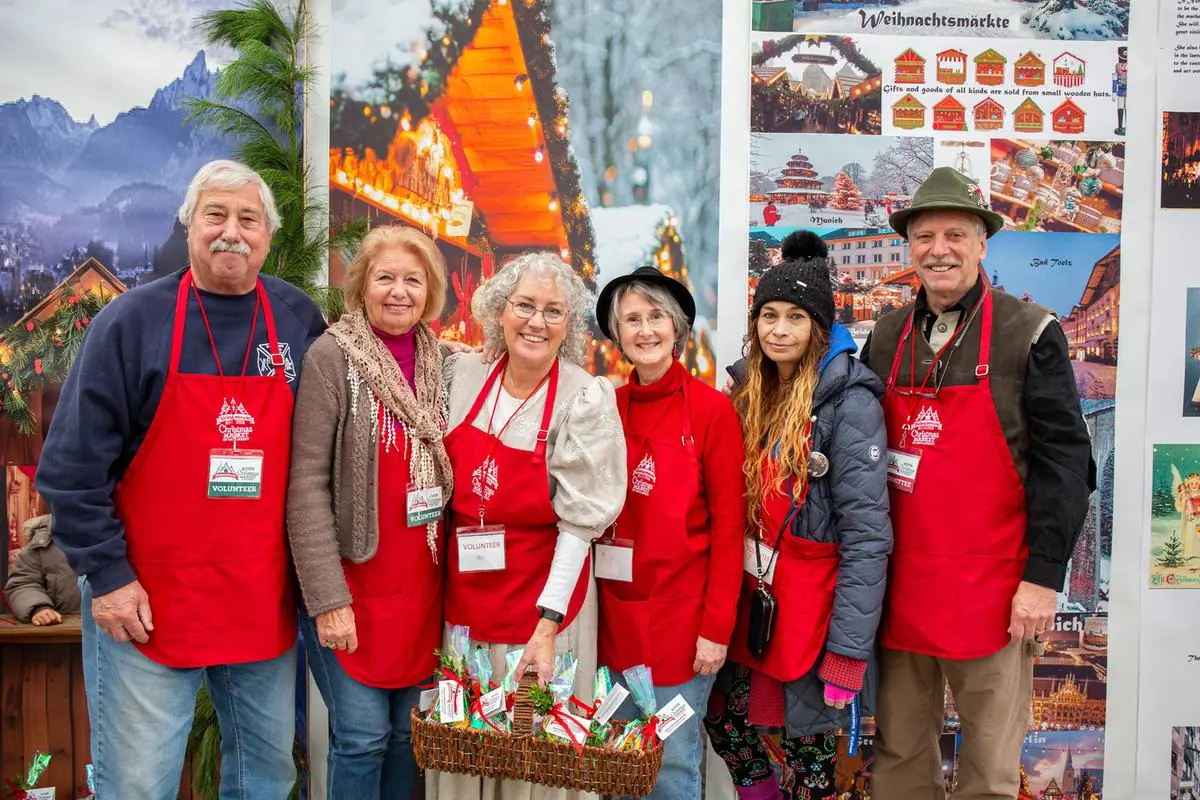 Volunteers in red aprons at the German Christmas Market of NJ at the Sussex County Fairgrounds in Augusta