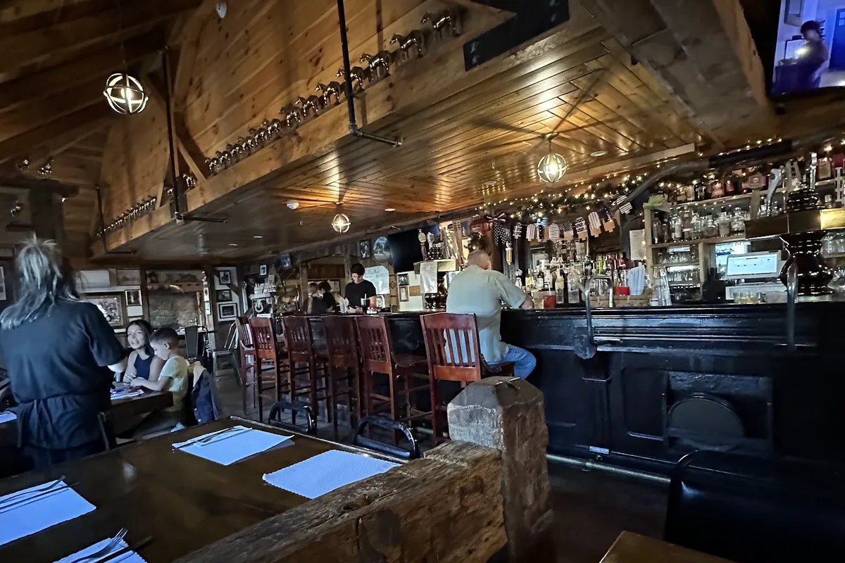 Wood-beamed dining room and bar inside The Homestead Rest in Sparta, NJ