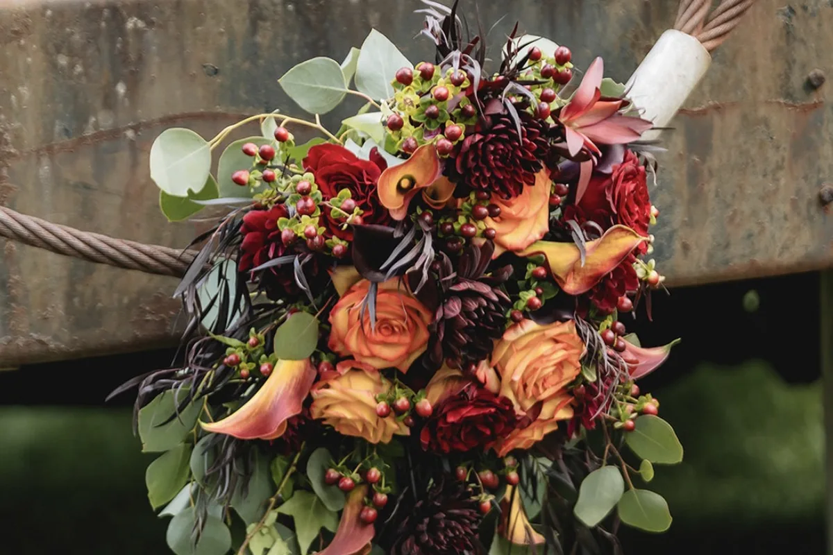 Fall bouquet of orange and burgundy flowers by Ibranyi is Floral of Newton NJ