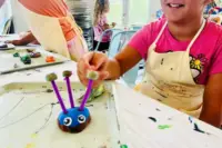 Child shows off a clay creature made at The ART Project kids art studio in Sparta, NJ