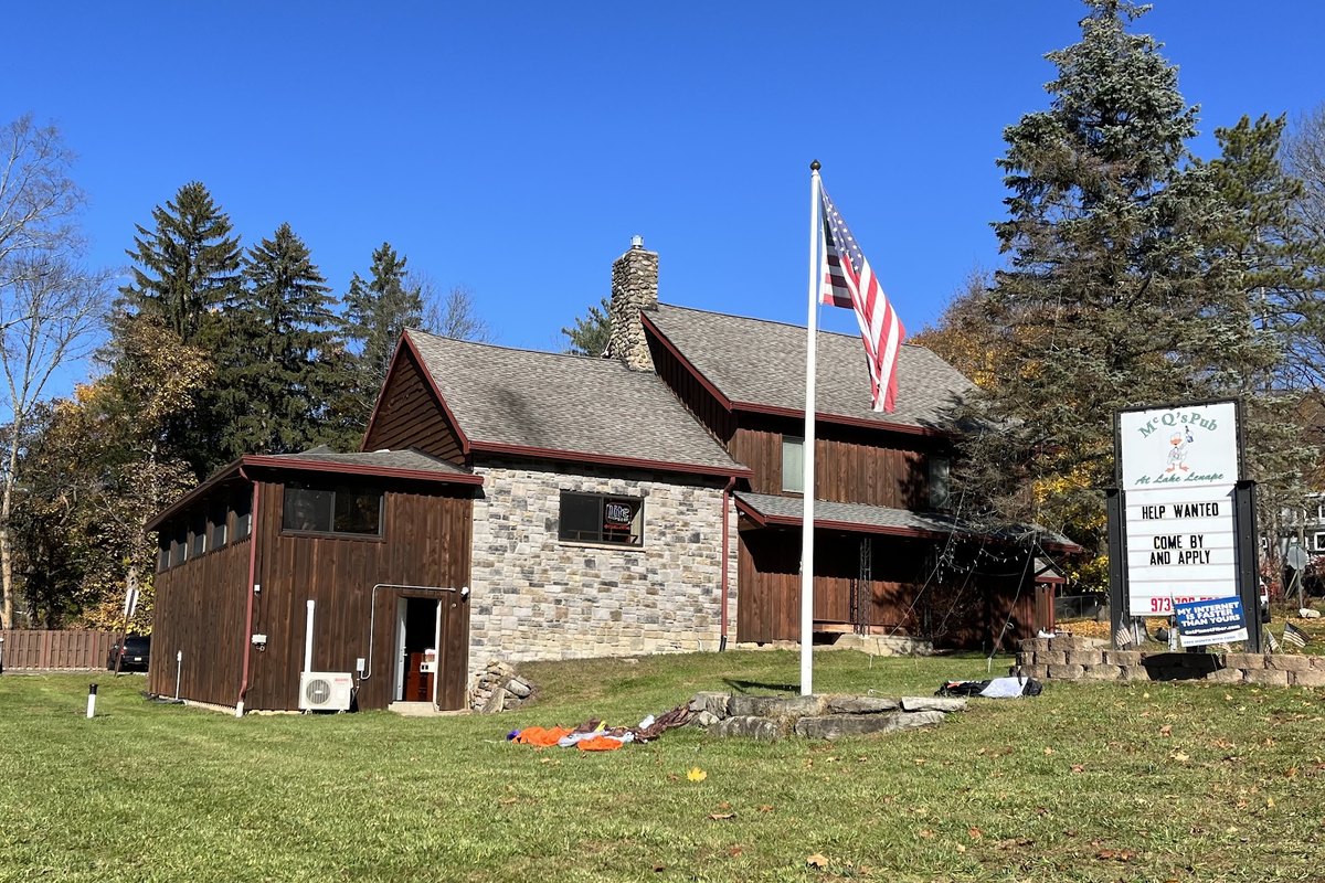 Stone building and flagpole at McQ's Pub at Lake Lenape in Andover Township, NJ