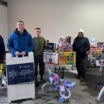 Norwescap volunteers and U.S. Marines with donated toys and bikes at the Winter Wonderland drop-off in Phillipsburg, NJ