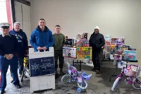 Norwescap volunteers and U.S. Marines with donated toys and bikes at the Winter Wonderland drop-off in Phillipsburg, NJ