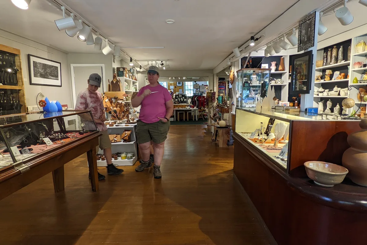 Shoppers browsing handmade pottery and crafts inside Peters Valley Gallery in Layton, NJ