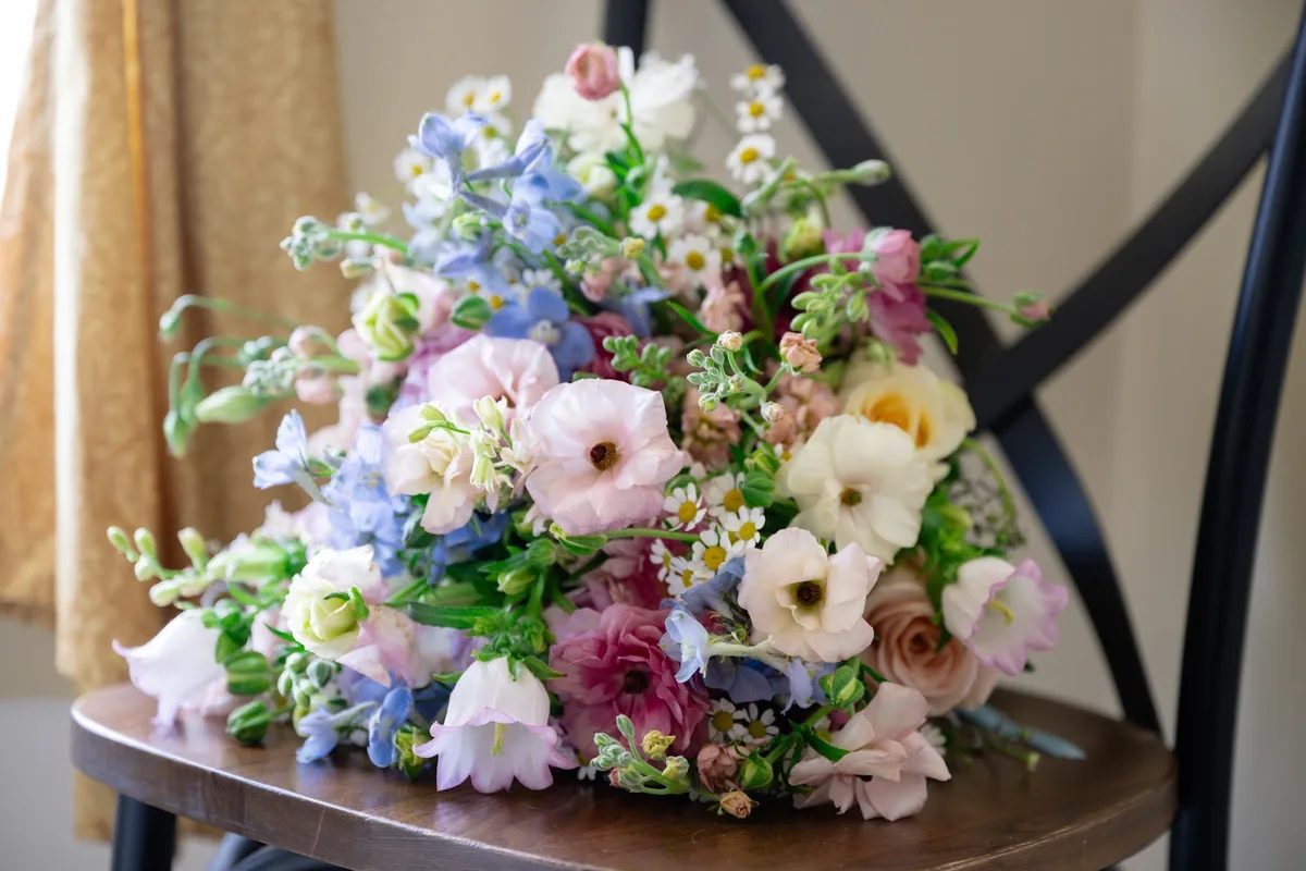 Pastel bouquet by Presto Flowers of Andover NJ resting on a chair