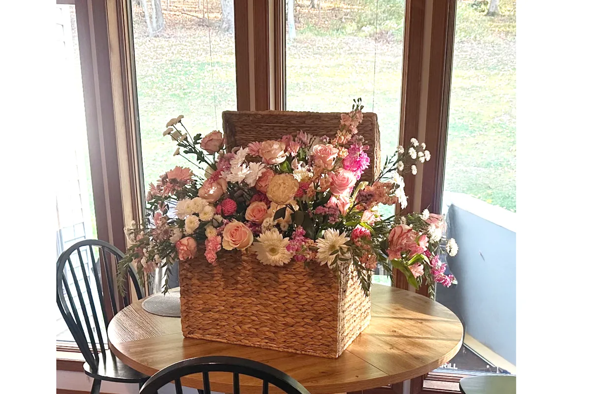 Basket arrangement of pink and peach flowers at Sussex County Florist on Route 23 in Wantage NJ