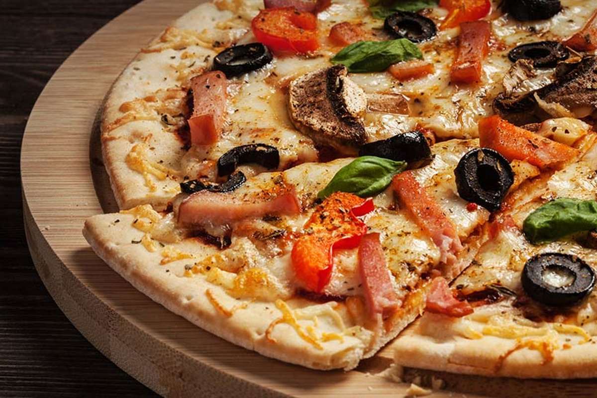 A pizza on a wooden board from Tony's Pizza and Pasta Restaurant in Hamburg, NJ