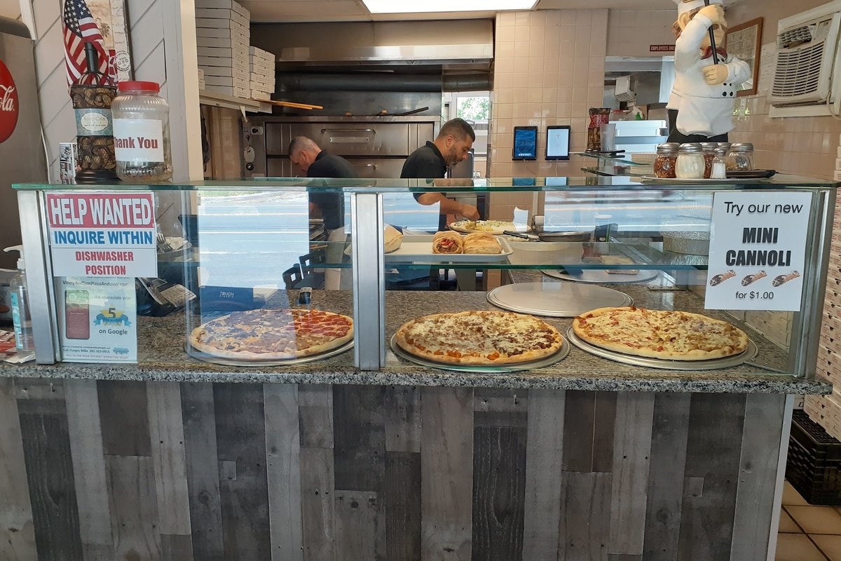 Pizza counter with whole pies on display at Vinny and Son Pizza on Main Street in Andover, NJ